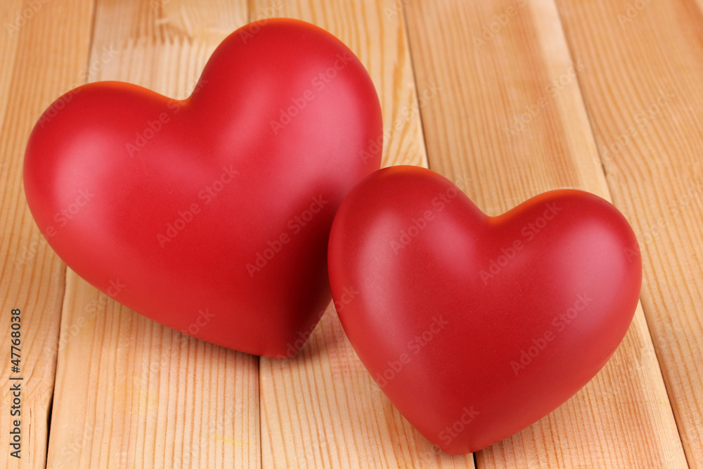 Decorative red hearts close-up on wooden table Decorative red hearts close-up on wooden table