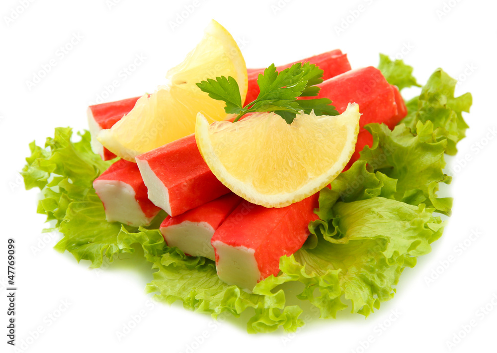 Crab sticks on lettuce leaves with lemon, isolated on white Crab sticks on lettuce leaves with lemon, isolated on white