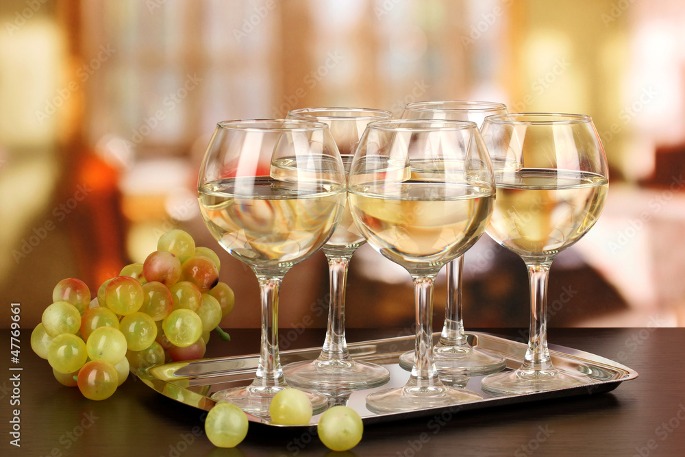 White wine in glass on room background White wine in glass on room background