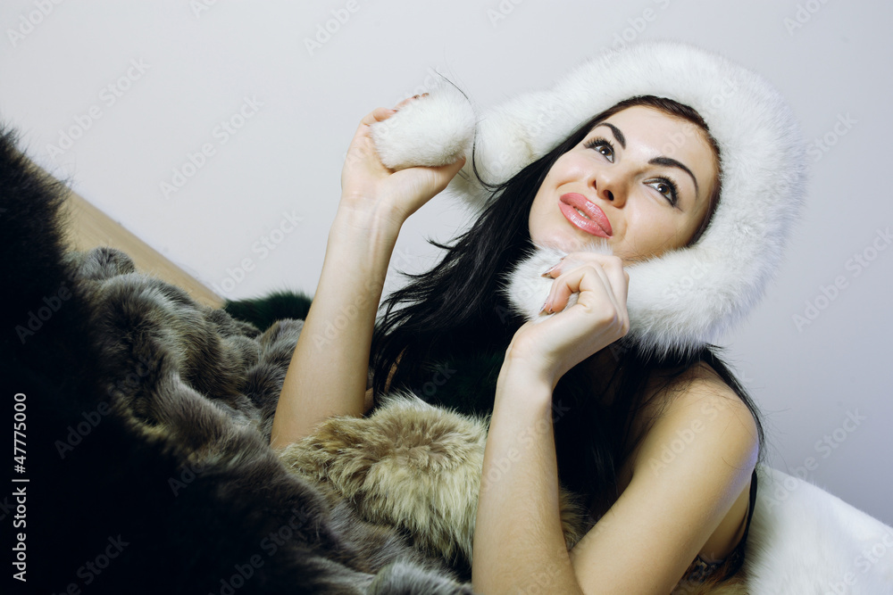 young girl with several natural fur coats young girl with several natural fur coats