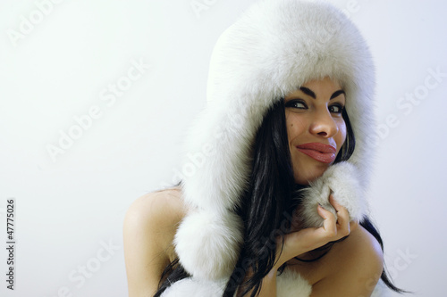 young girl with several natural fur coats