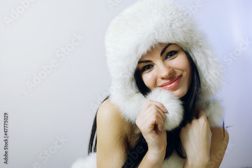 young girl with several natural fur coats