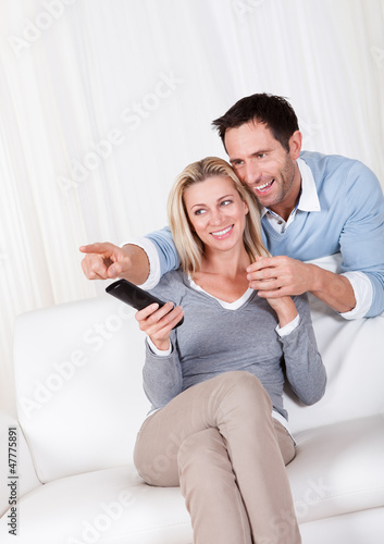Cheerful couple watching TV