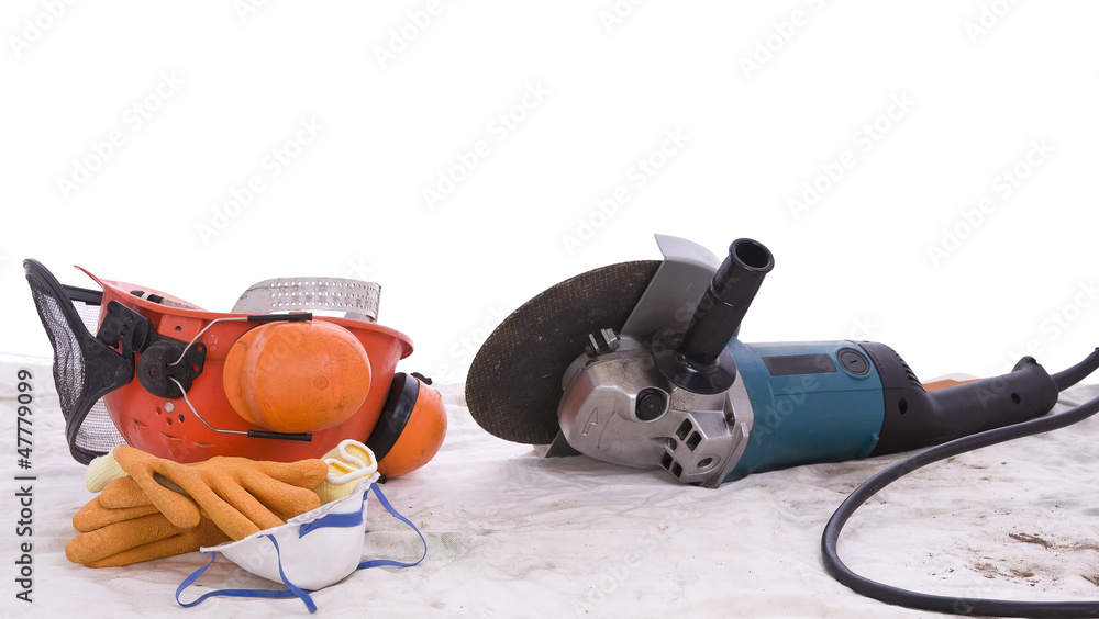 angle grinder and protective equipment on dust sheet angle grinder and protective equipment on dust sheet