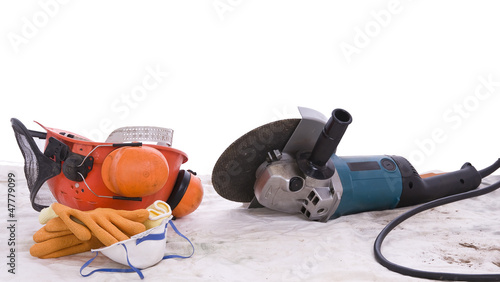 angle grinder and protective equipment on dust sheet