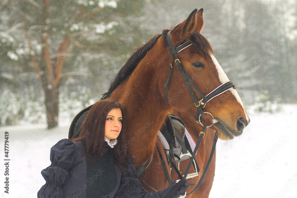 Obraz premium Beautiful woman and horse in winter