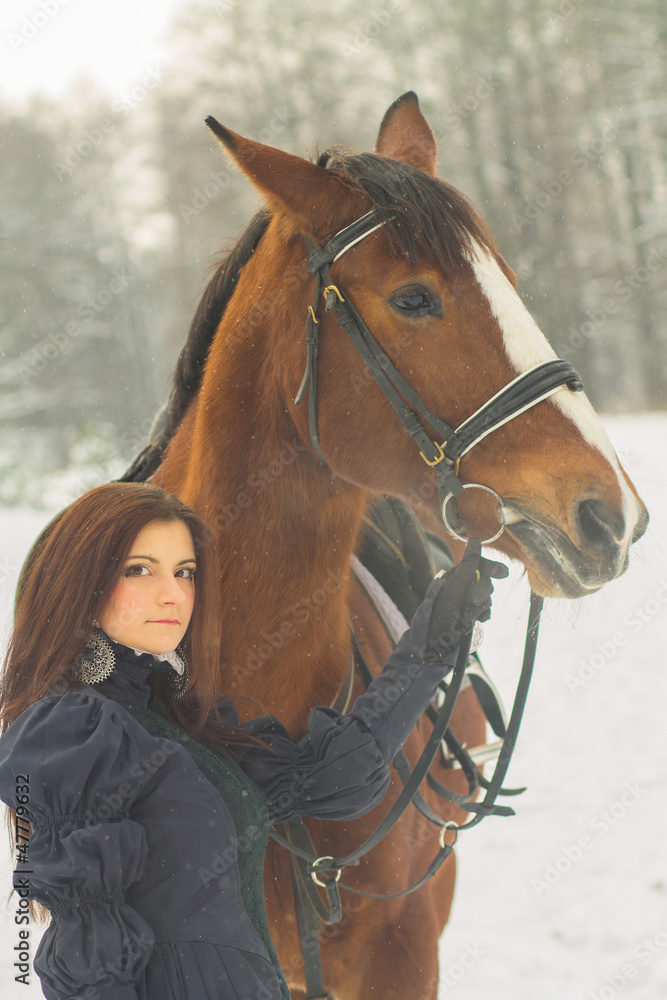 Obraz premium Beautiful woman and horse in winter