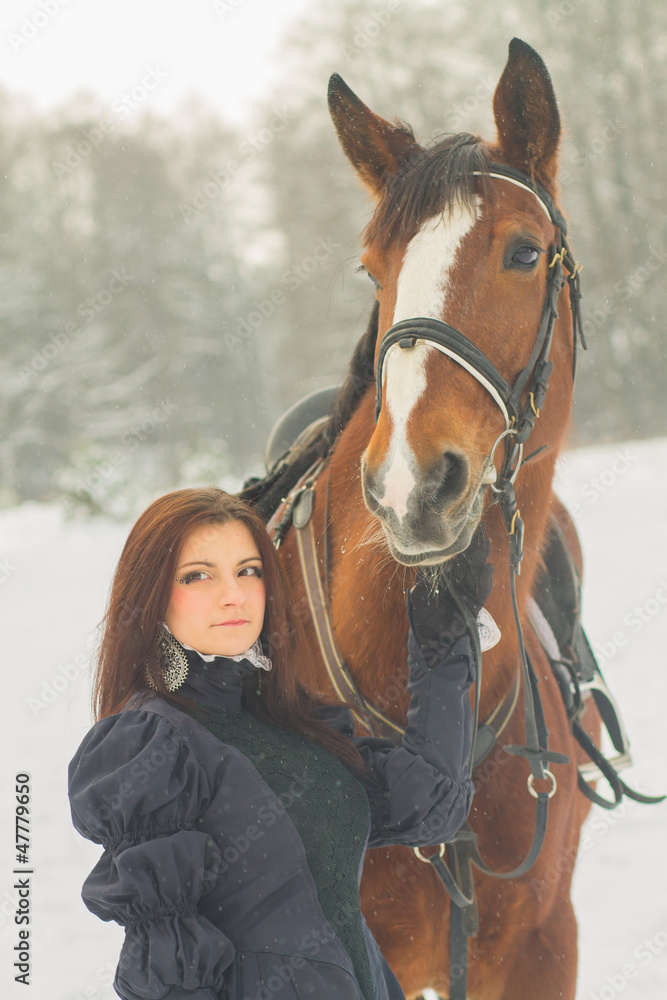 Obraz premium Beautiful woman and horse in winter