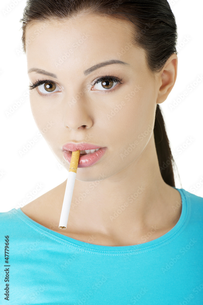 Young woman with cigarette in her mouth. Young woman with cigarette in her mouth.