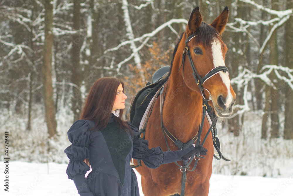Obraz premium Beautiful woman and horse in winter