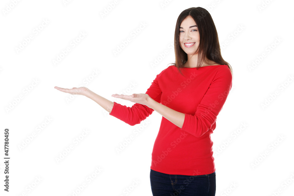 Excited young woman presenting copy space Excited young woman presenting copy space
