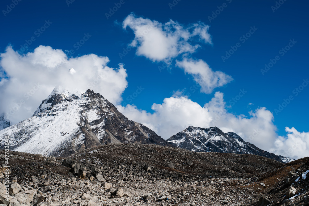 Summit and clouds near Sacred Lake of Gokyo in Himalayas