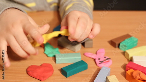 little girl play with plasticine