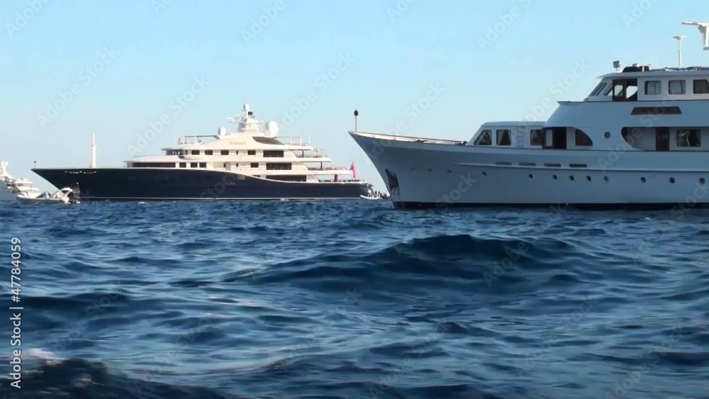 Beautiful yachts floating on the surface of the sea Beautiful yachts floating on the surface of the sea