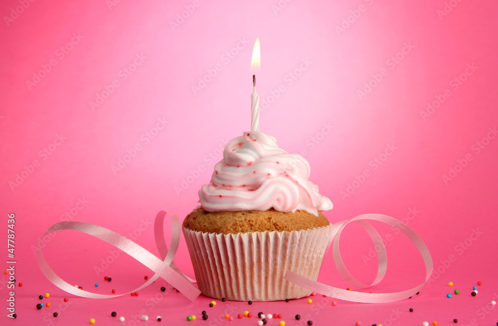 tasty birthday cupcake with candle, on pink background tasty birthday cupcake with candle, on pink background