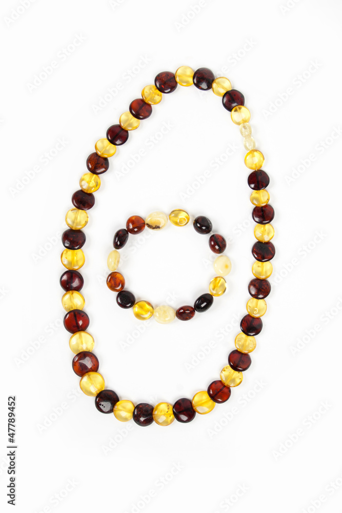Amber beads and bracelet of bright transparent amber close up is Amber beads and bracelet of bright transparent amber close up is