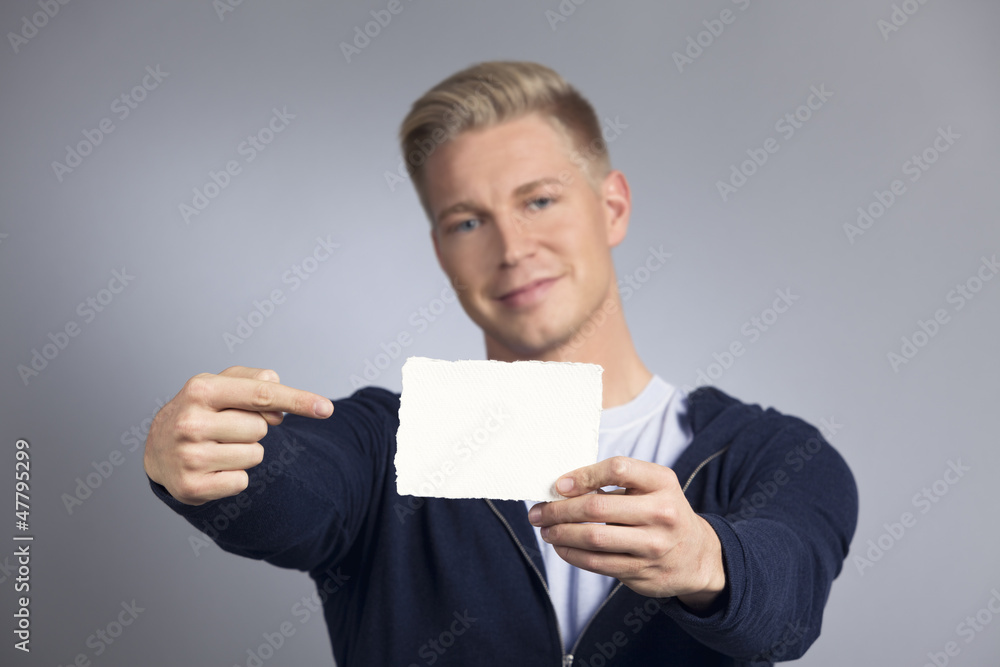 Smiling man showing empty white card. Smiling man showing empty white card.