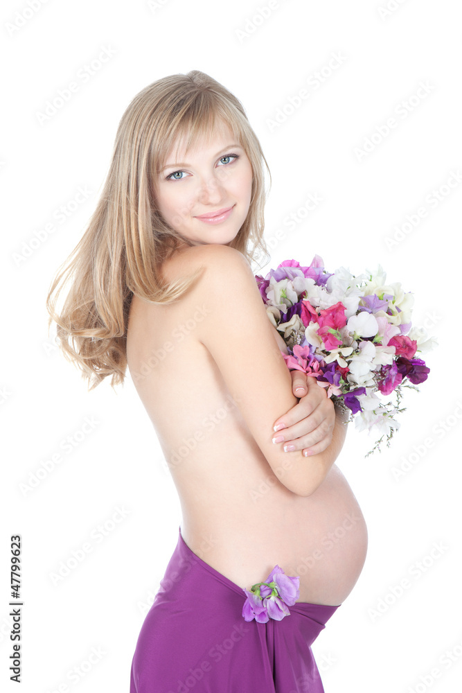 Young beautiful pregnant woman with flowers