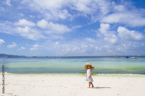 young child girl in summer hat on tropical sea background