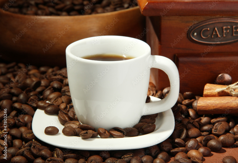cup of coffee, grinder and coffee beans on brown background cup of coffee, grinder and coffee beans on brown background