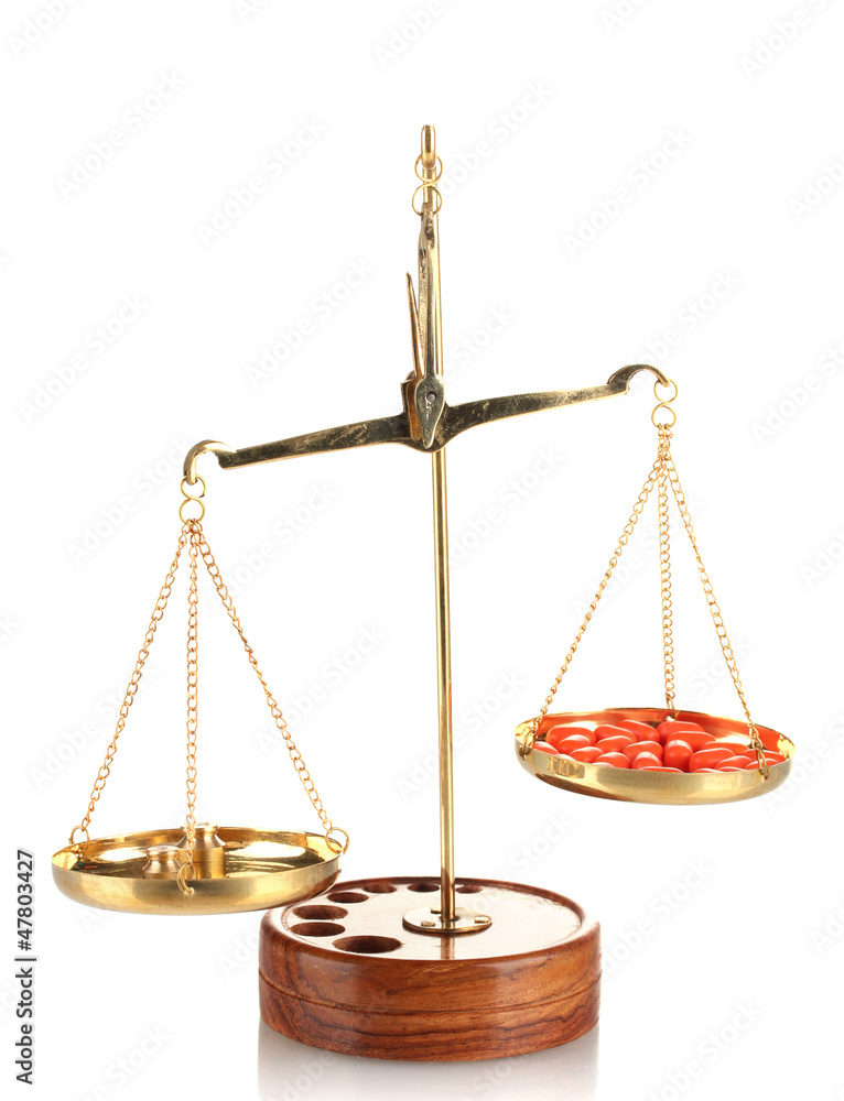 Classic scales with color pills isolated on white Classic scales with color pills isolated on white