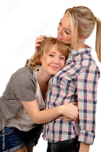 Female friends taking comfort from each other