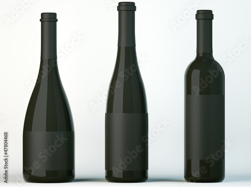 Three corked bottles for wine with black labels