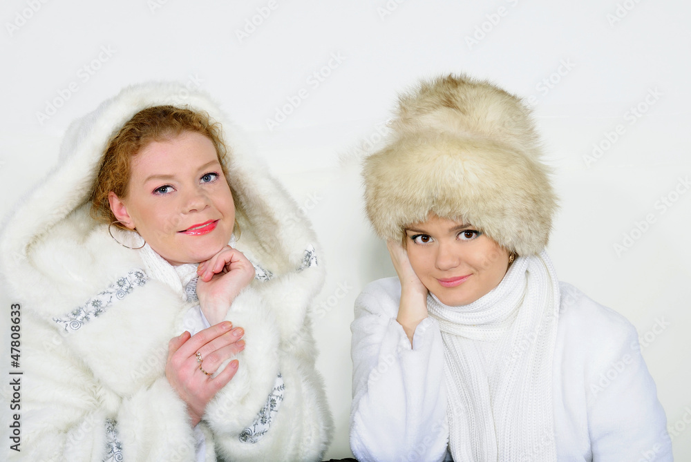 Two young beautiful girls with gifts on a white background Two young beautiful girls with gifts on a white background