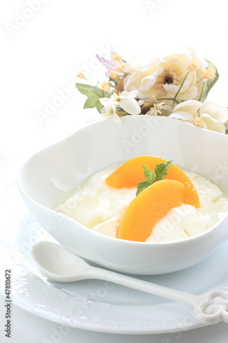 healthy dessert, peach and yogurt with flower on background