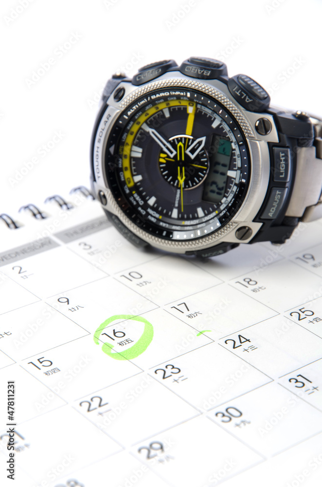 Wrist watch on the calendar background Wrist watch on the calendar background