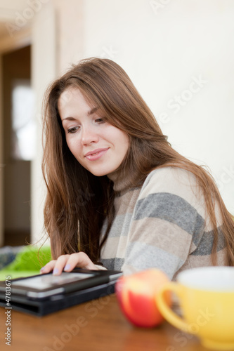 Young woman reads e-reader