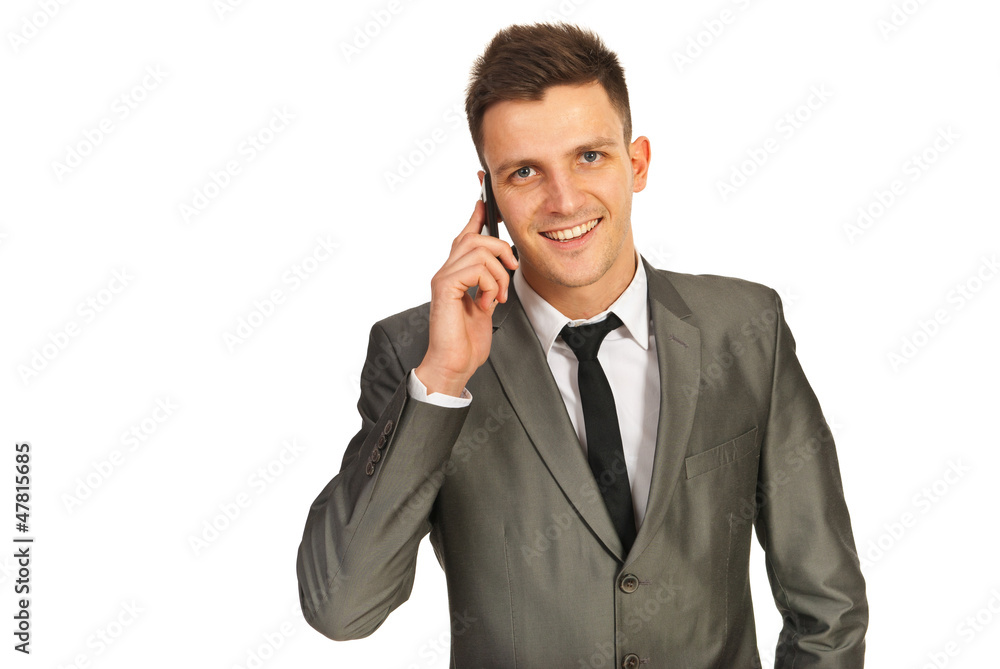 Smiling businessman by phone Smiling businessman by phone