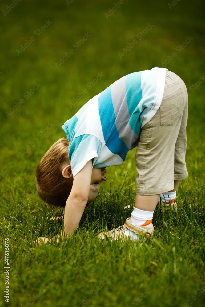 the little boy looks upside down the little boy looks upside down