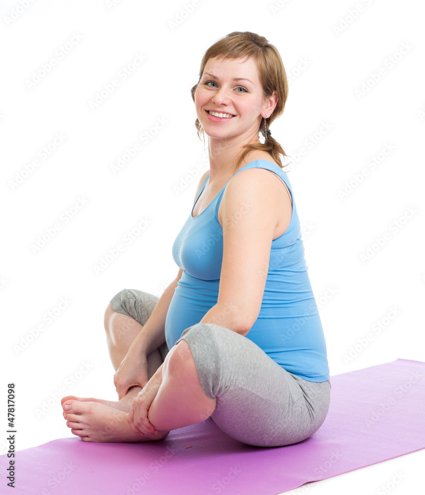 Pregnant woman doing gymnastic exercises isolated on white Pregnant woman doing gymnastic exercises isolated on white