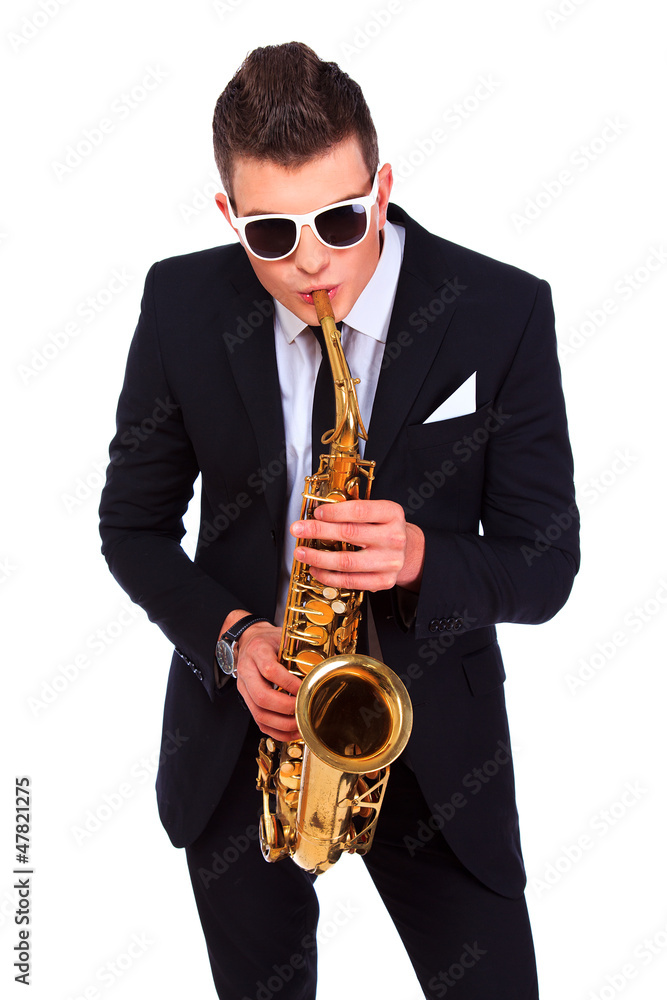 Fototapeta premium Saxophonist in a suit and modern sunglasses