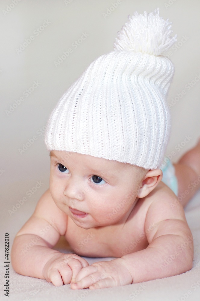 Portrait of the baby in a white knitted hat (3 months) Portrait of the baby in a white knitted hat (3 months)