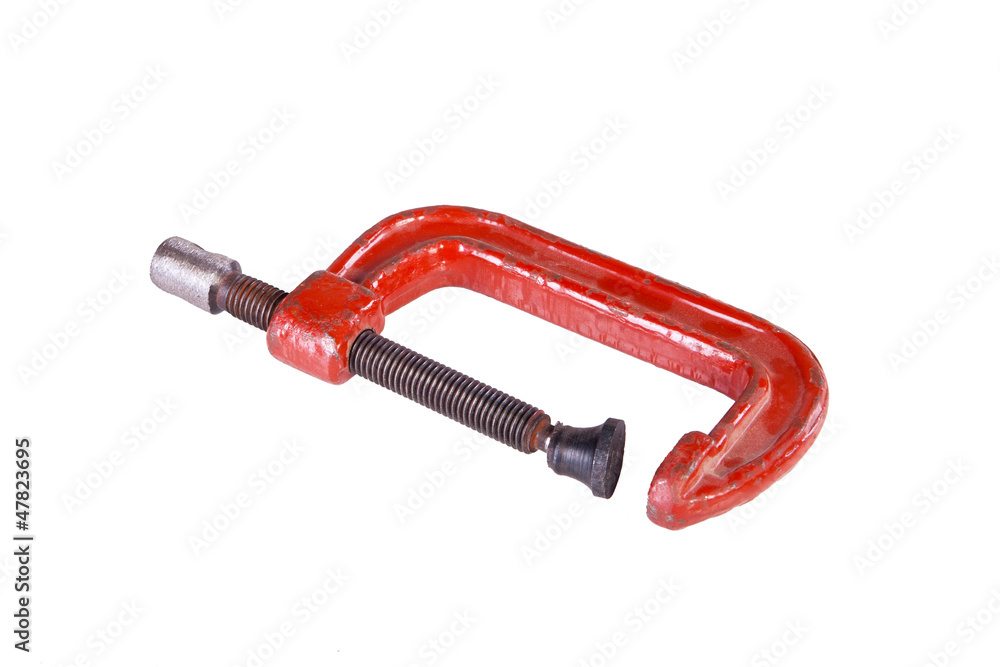 A small old metal red c-clamp isolated on white. A small old metal red c-clamp isolated on white.