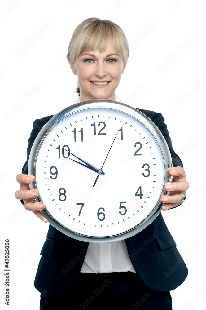 Business executive displaying big wall clock Business executive displaying big wall clock