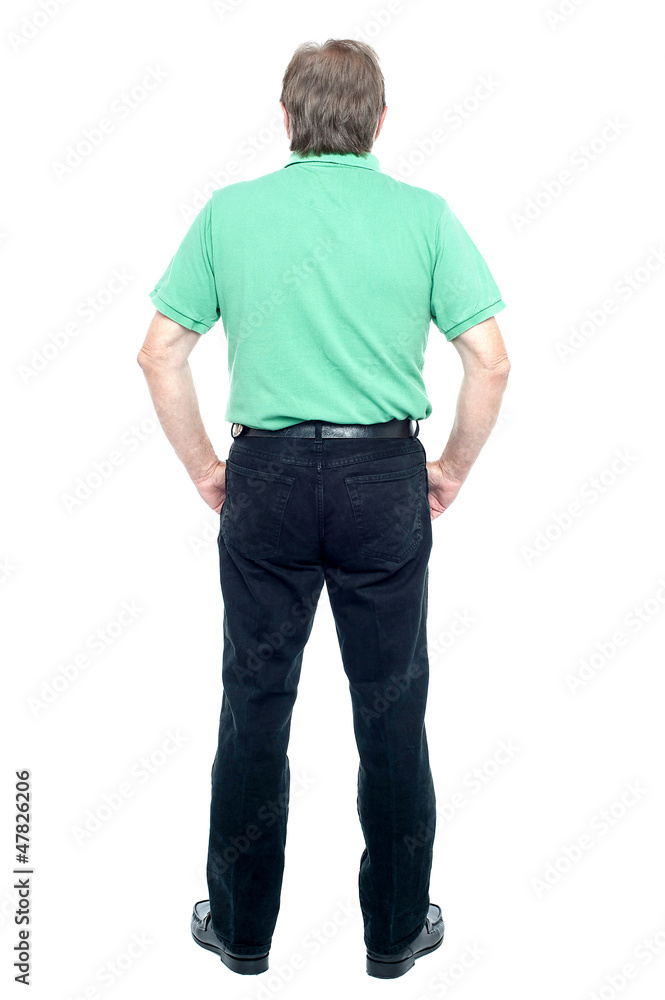 Back pose of a senior man looking at the wall Back pose of a senior man looking at the wall