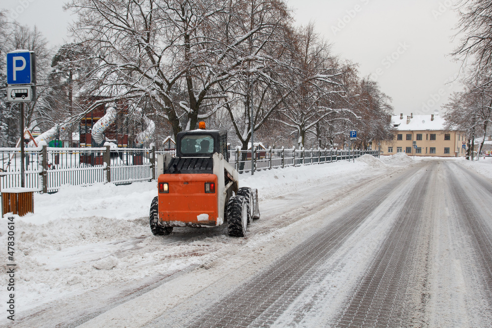 Obraz premium small excavator bobcat working on the street