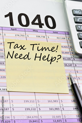 Tax forms 1040, spread sheet with pen, calculator and sticker.