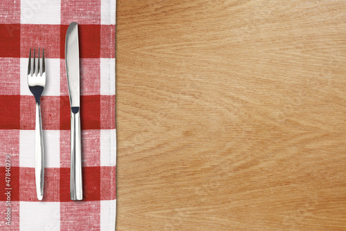 Fork and tableknife on red ...