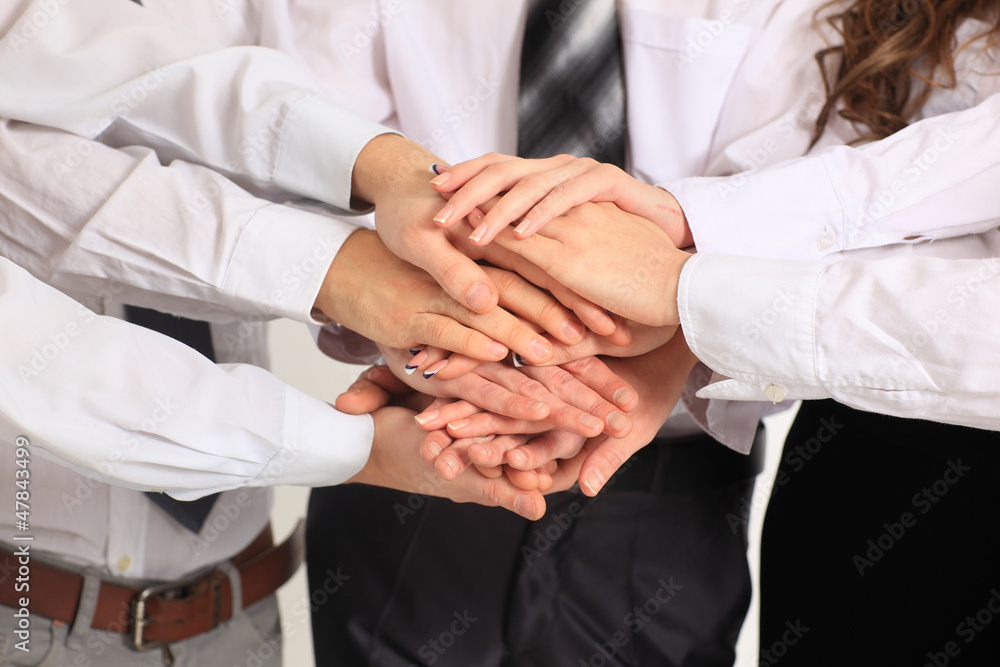 business team putting their hands on top business team putting their hands on top