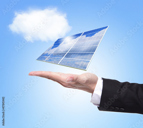 Business man hold solar panel