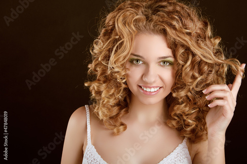Attractive smiling teen girl with Curly Hair wavy hair, curl on