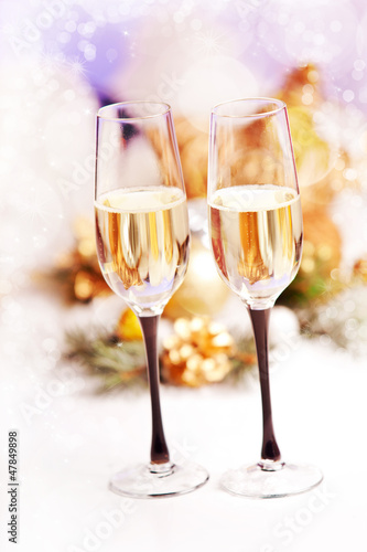 New Year and Christmas Celebration .Two Champagne Glasses in Hol