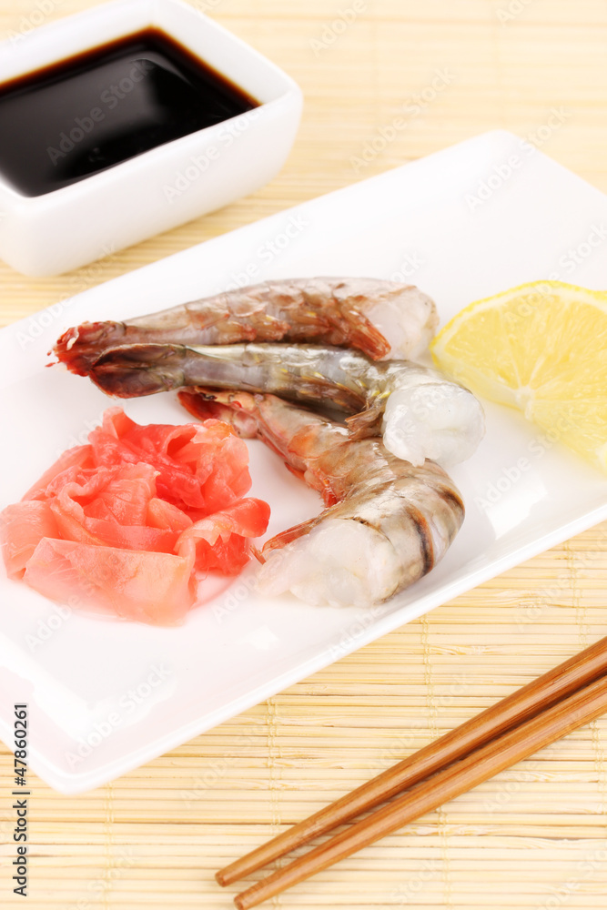 Prawn skewers on plate with ginger and lemon Prawn skewers on plate with ginger and lemon