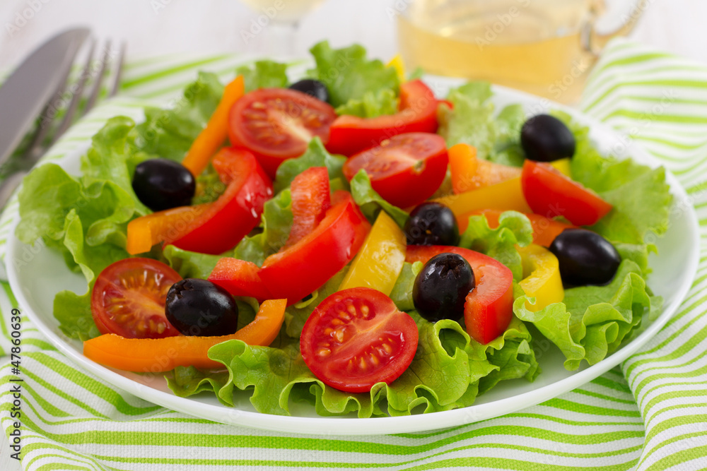 salad with pepper and olives on the plate