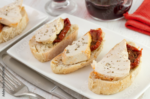 bread with chicken and dried tomato and red wine