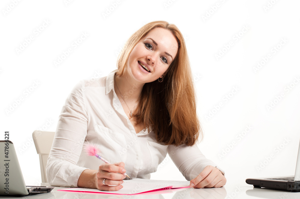 woman sitting at a desk in an office with an open notebook woman sitting at a desk in an office with an open notebook